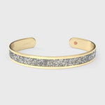 Close-up of SWAROVSKI® Diamond crystal fabric inlay on gold cuff, showing mirror-like brilliance and precision-cut detail