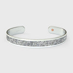 Close-up of SWAROVSKI® Diamond crystal fabric inlay on sterling silver cuff showing precision-cut sparkle and reflective brilliance