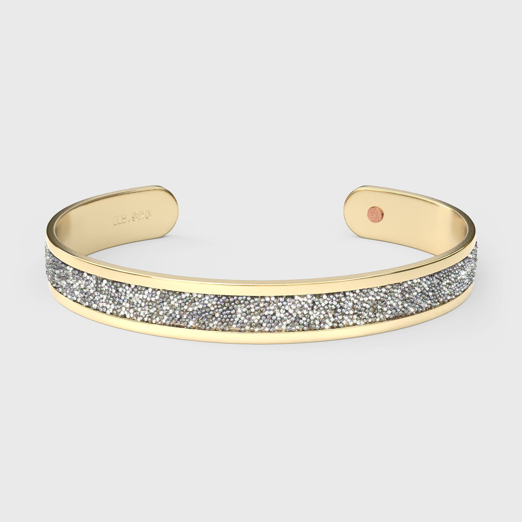 Close-up of SWAROVSKI® Diamond crystal fabric inlay on gold cuff, showing mirror-like brilliance and precision-cut detail